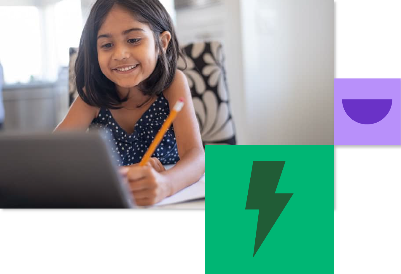 This image shows a young student smiling while working on a laptop computer. She has shoulder-length dark hair and is wearing a navy blue polka dot dress or top. She's holding a yellow pencil and appears to be engaged in an educational activity. 
