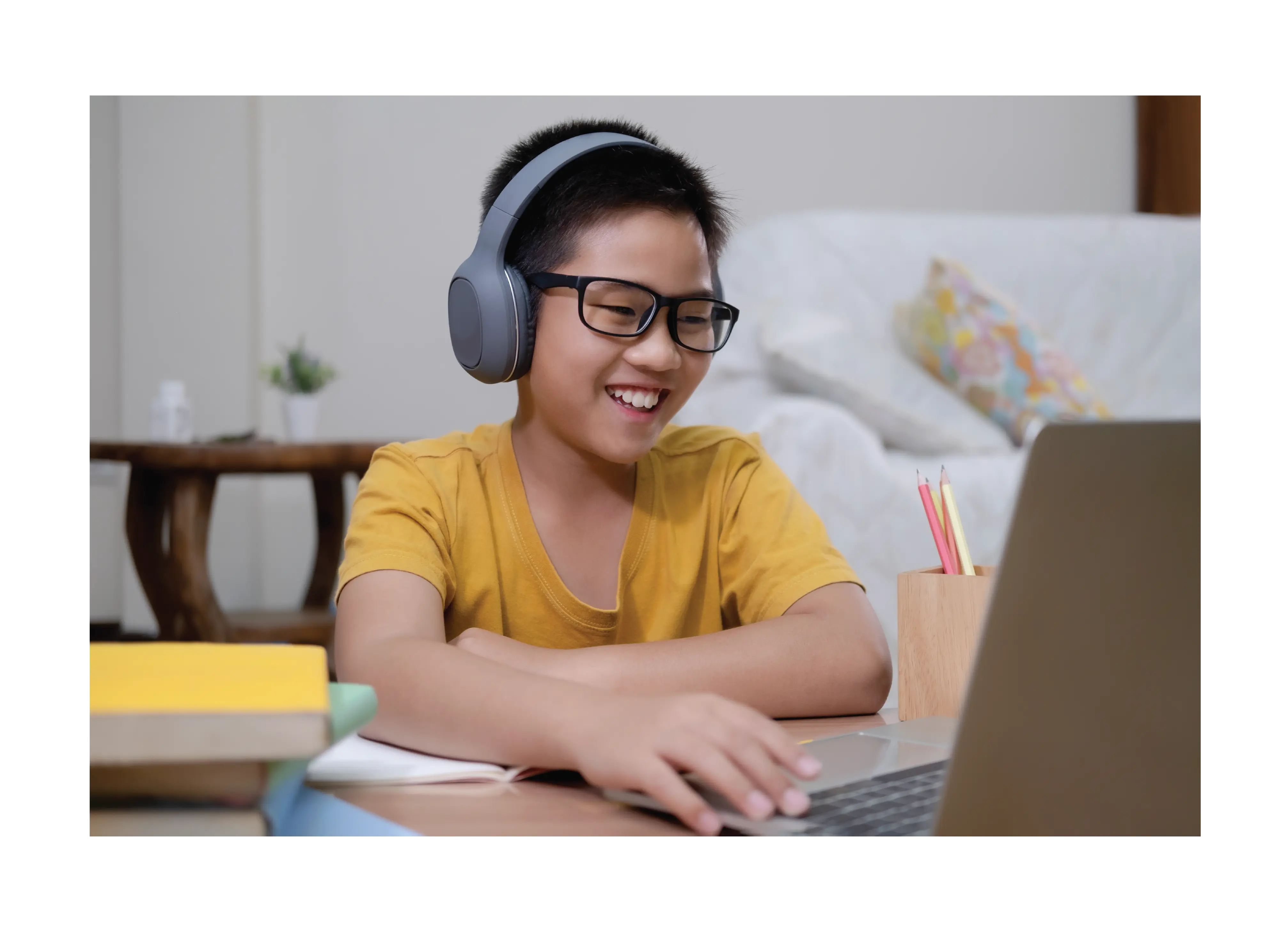 Student participating in a virtual class with headphones and a laptop, showcasing the accessibility of online education.
