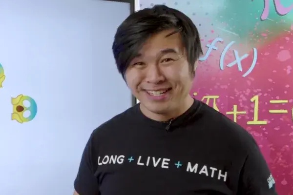 Howie Hua, a math teacher, in front of a whiteboard in a math video in MATHstream.